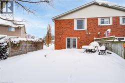 Snow covered property with brick siding - 
