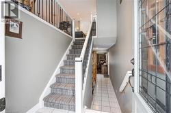 Stairs featuring tile patterned floors and a towering ceiling - 