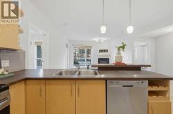 Open layout - kitchen overlooks living room area with lots of natural light - 