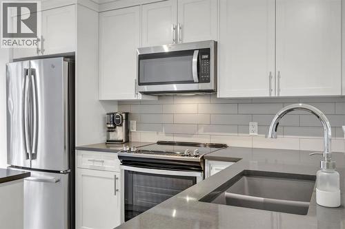 Kitchen - 623 Cranbrook Walk Se, Calgary, AB - Indoor Photo Showing Kitchen With Stainless Steel Kitchen With Double Sink With Upgraded Kitchen