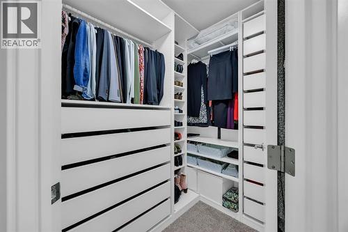 Walk In Closet in Primary Bedroom #1 - 623 Cranbrook Walk Se, Calgary, AB - Indoor With Storage