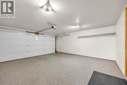Double Attached Garage with Epoxy Floors and Heater - 623 Cranbrook Walk Se, Calgary, AB - Indoor Photo Showing Garage