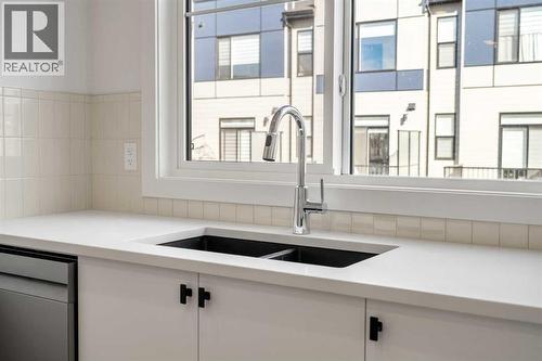 302, 550 Seton Circle Se, Calgary, AB - Indoor Photo Showing Kitchen With Double Sink