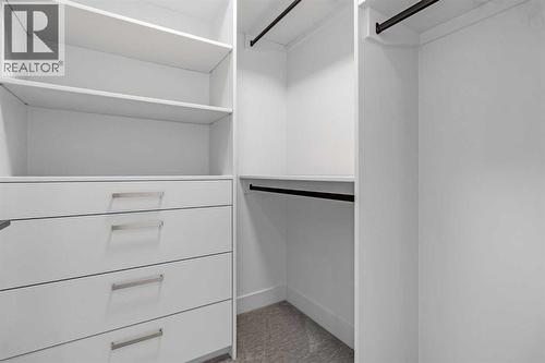 BEDROOM 2 WALK IN CLOSET - 340 West Chestermere Drive, Chestermere, AB - Indoor With Storage