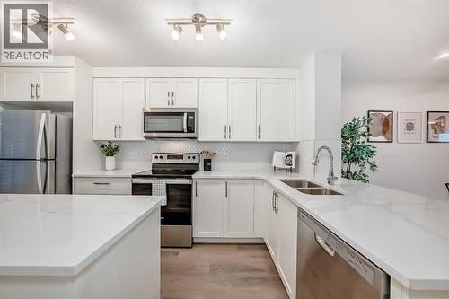 307, 474 Seton Circle Se, Calgary, AB - Indoor Photo Showing Kitchen With Stainless Steel Kitchen With Double Sink With Upgraded Kitchen