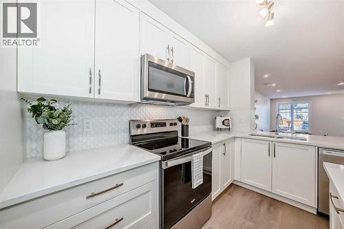 307, 474 Seton Circle Se, Calgary, AB - Indoor Photo Showing Kitchen With Stainless Steel Kitchen With Double Sink With Upgraded Kitchen