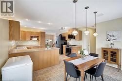Dining room with light floors and recessed lighting - 