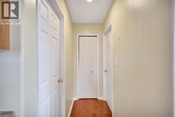 Corridor with light wood-style floors and baseboards - 
