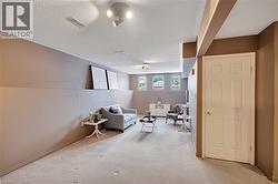 Sitting room featuring light colored carpet and a textured ceiling - 