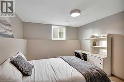 Bedroom featuring a textured ceiling and light colored carpet - 