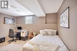 Bedroom with a desk and light carpet - 