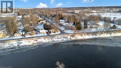 Snowy aerial view with a residential view and a water view - 