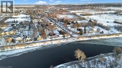 Snowy aerial view with a water view and a residential view - 