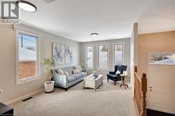 Carpeted living area with baseboards - 