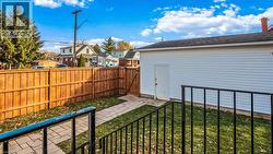 Fenced backyard with a patio area and a residential view - 
