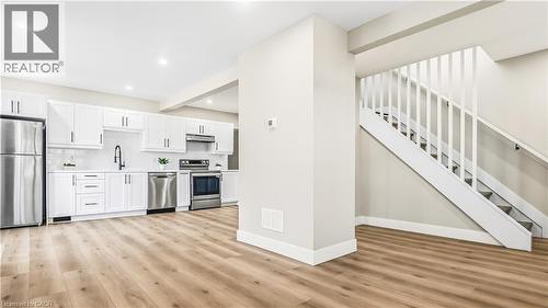 Kitchen with stainless steel appliances, light countertops, white cabinetry, light wood-style flooring, and recessed lighting - 491 Upper Wentworth Street, Hamilton, ON - Indoor Photo Showing Kitchen