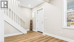 Foyer with stairs and wood finished floors - 