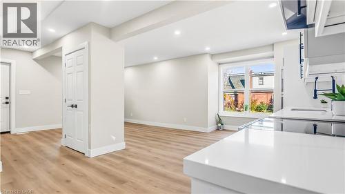 Kitchen with light wood finished floors, recessed lighting, and light stone counters - 491 Upper Wentworth Street, Hamilton, ON - Indoor
