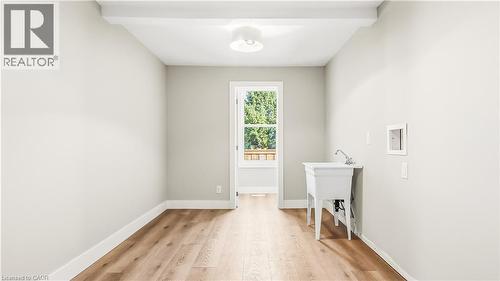 Laundry room with light wood-style floors, washer hookup, and beamed ceiling - 491 Upper Wentworth Street, Hamilton, ON - Indoor Photo Showing Other Room