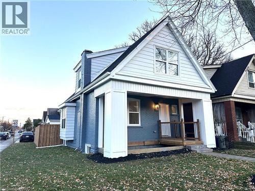 View of front of home featuring brick siding, covered porch, and a front lawn - 491 Upper Wentworth Street, Hamilton, ON - Outdoor