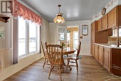 Diningrm luxury vinyl plank floor; door to sunroom - 