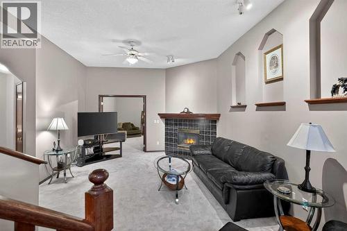 150 Somerset Close Sw, Calgary, AB - Indoor Photo Showing Other Room With Fireplace
