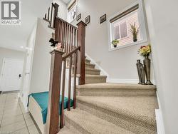 Stairway with tile patterned flooring and recessed lighting - 