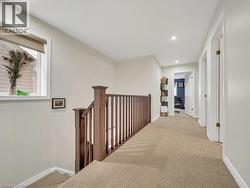 Hallway featuring carpet flooring, an upstairs landing, and recessed lighting - 