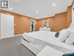 Carpeted bedroom with recessed lighting and a walk in closet - 