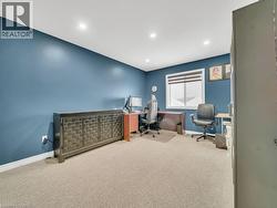 Carpeted office space with baseboards and recessed lighting - 