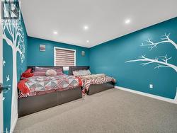 Carpeted bedroom with recessed lighting and baseboards - 