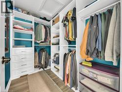 Spacious closet featuring wood finished floors and attic access - 