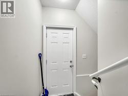 Entryway with a textured ceiling and vaulted ceiling - 