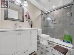 Full bathroom featuring vanity, a shower stall, and recessed lighting - 