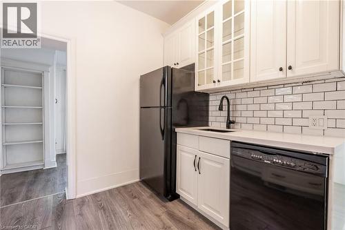 Both units' kitchens feature dishwashers. - 388 Charlton Avenue W, Hamilton, ON - Indoor Photo Showing Kitchen