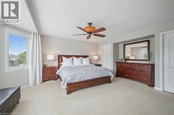 Primary Bedroom Suite with his and hers closets, electric fireplace, sitting area and 5-piece bathroom - 