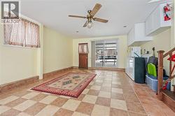 Foyer entrance featuring a ceiling fan and stairway - 