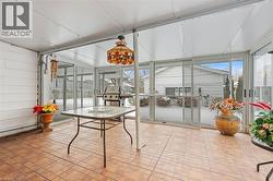 Sunroom with brick patterned flooring and wood walls - 