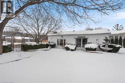 View of snow covered back of property - 