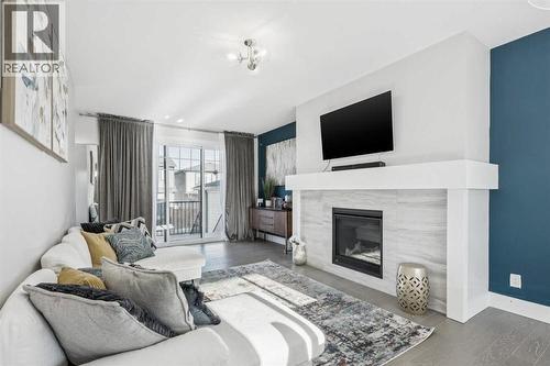 16 Treeline Lane Sw, Calgary, AB - Indoor Photo Showing Living Room With Fireplace