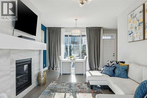 16 Treeline Lane Sw, Calgary, AB - Indoor Photo Showing Living Room With Fireplace