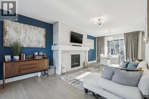 16 Treeline Lane Sw, Calgary, AB - Indoor Photo Showing Living Room With Fireplace