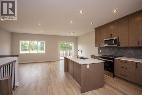 Photos and renderings are examples from a similar home built previously and do not necessarily reflect finished and colours used in this home - 37 Terra Close, Red Deer, AB - Indoor Photo Showing Kitchen
