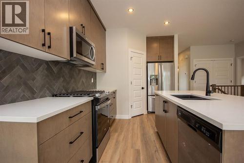 Photos and renderings are examples from a similar home built previously and do not necessarily reflect finished and colours used in this home - 37 Terra Close, Red Deer, AB - Indoor Photo Showing Kitchen With Stainless Steel Kitchen With Upgraded Kitchen