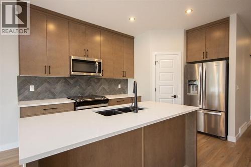Photos and renderings are examples from a similar home built previously and do not necessarily reflect finished and colours used in this home - 37 Terra Close, Red Deer, AB - Indoor Photo Showing Kitchen With Stainless Steel Kitchen With Double Sink