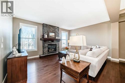 49 Crestridge View Sw, Calgary, AB - Indoor Photo Showing Living Room With Fireplace