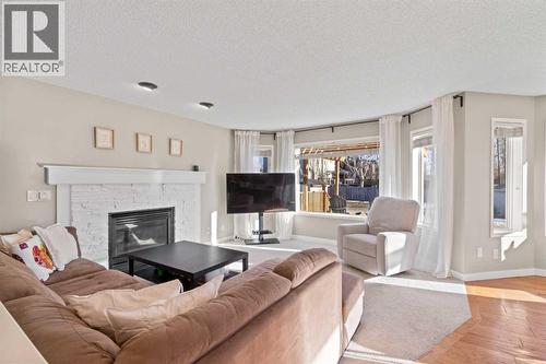 21 Wilson Road Ne, Langdon, AB - Indoor Photo Showing Living Room With Fireplace
