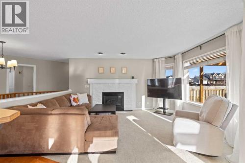 21 Wilson Road Ne, Langdon, AB - Indoor Photo Showing Living Room With Fireplace