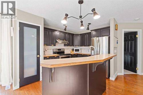 21 Wilson Road Ne, Langdon, AB - Indoor Photo Showing Kitchen With Stainless Steel Kitchen