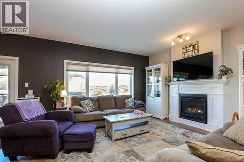 711 Moonlight Crescent W, Lethbridge, AB - Indoor Photo Showing Living Room With Fireplace